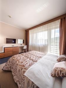 Postel nebo postele na pokoji v ubytování Hotel Macola