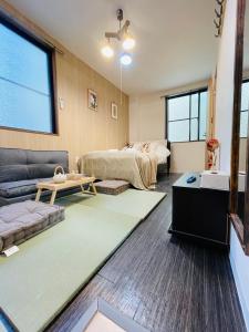 a living room with a bed and a couch at Sky house晴空塔2 in Tokyo
