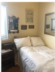 a bedroom with a bed and a table and a mirror at Comfortable Cozy and Convenient rooms for rent in Toronto