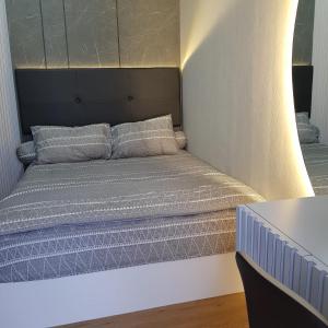 a bed in a room with a light on it at One Residence Batam Unit 3AB in Batam Center
