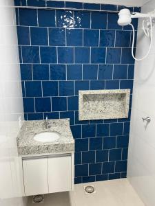 a blue tiled bathroom with a sink and a shower at Residencial Berakah in Rio Verde +34 photos