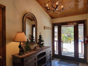 a living room with a mirror and a lamp at Four Seasons Getaway-with Hot Tub, Next to Village and Hiking Trailhead in Big Bear Lake