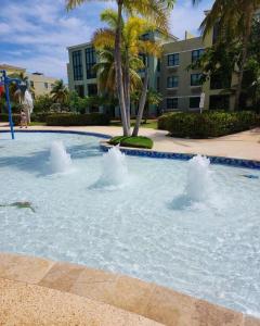 a swimming pool with water fountain in a resort at Aquatika Paraíso Tropical in Loiza