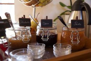 a group of jars of honey on a table at La Grange de Boulaines in Méru +9 photos
