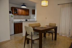 una cucina con un tavolo e sedie in legno in una stanza di Patagonia 55 a Neuquén