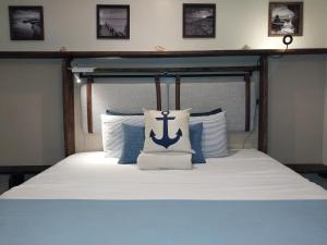a bedroom with a bed with an anchor pillow on it at Apartment near Grace Bay Beach in Providenciales