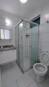 a bathroom with a toilet and a glass shower at Apê com vista espetacular no Edif. Mr. Roterdam in Caruaru