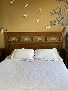 a bedroom with a bed with two pillows on it at C & N - Altos de la Bahía in El Calafate