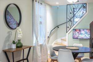 a dining room with a table and chairs and a staircase at Cozy & Inviting Townhome in Frederick