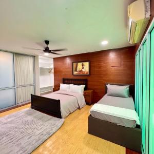 a bedroom with two beds and a ceiling fan at Pertak Malai @ Kuala Kubu Bharu in Kuala Kubu Baharu