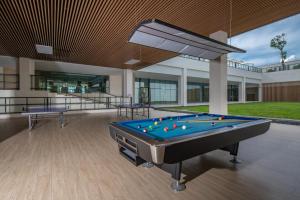 a pool table in the middle of a building at Sanya Haitang Bay Moutai Resort Classic Hotel in Sanya