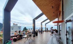 a group of people on a deck with a view of the ocean at Lego Homestay Tam Đảo Venuestay in Vĩnh Phúc