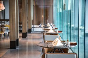 a row of tables and chairs in a restaurant at Sanya Haitang Bay Moutai Resort Superior Hotel in Sanya