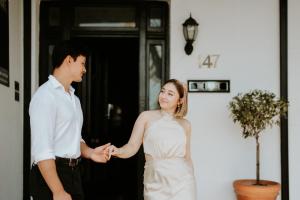 a bride and groom holding hands in front of a door at The Bronte Boutique Hotel in Morpeth