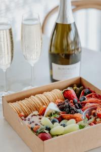 a box of fruit with a bottle of wine and glasses at The Bronte Boutique Hotel in Morpeth