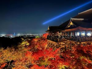 a chinese building at night with autumn leaves at Rinn Gion Kenninji in Kyoto