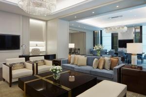 a living room with a couch and a table at The St. Regis Kuala Lumpur in Kuala Lumpur