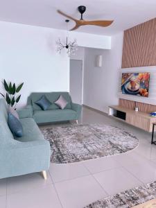 a living room with a blue couch and a rug at The Halt Putrajaya in Putrajaya