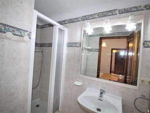 a bathroom with a sink and a shower and a mirror at Apartments La Pineda, Playa de Pals in Begur