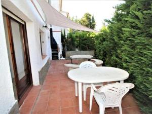 a patio with two tables and chairs on a patio at Apartments La Pineda, Playa de Pals in Begur