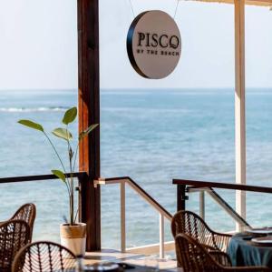 a restaurant with a table and chairs and a view of the ocean at Jubilee hotel in Calangute