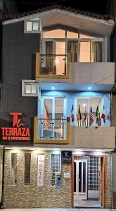 a building with a sign on the side of it at LA TERRAZA INN in Huancavelica