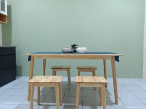 une table avec deux tabourets et un comptoir bleu dans l'établissement BS Home in Miri City - 3R2B House, à Miri