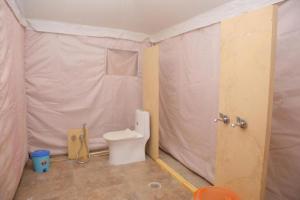 a bathroom with a toilet in a tent at Charisma Desert Camping in Jaisalmer