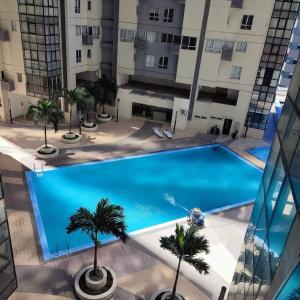 an overhead view of a large swimming pool in a building at L1 Twin Bed Staycation in Bonifacio Global City 4 in Manila