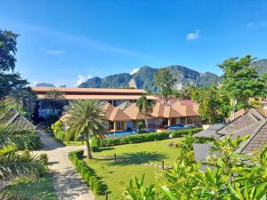 an aerial view of a resort with mountains in the background at U Rip Resort in Phi Phi Islands