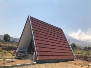 a house with a red roof on top of it at Villa Eger Rinjani in Sembalun Lawang