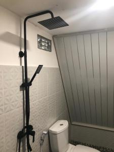 a bathroom with a toilet and a shower stall at Villa Eger Rinjani in Sembalun Lawang