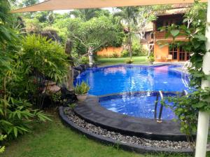 a swimming pool in the yard of a house at Villa Tenganan, Candidasa, Bali in Candidasa