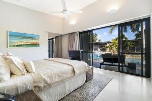 a bedroom with a bed and a view of the ocean at Mindil Beach Casino Resort in Darwin