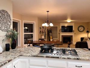 a kitchen with a stove top in a living room at Sopra Bella- 4 bedroom home in Corvallis
