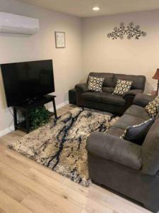 a living room with a couch and a flat screen tv at Valley Escape in Quiet Area Neighborhood in Spokane Valley