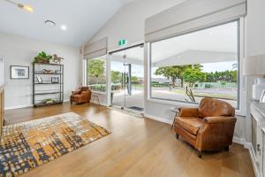 a living room with a large window and a chair at Hunter Oasis in Morpeth