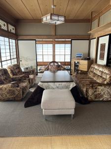 a large living room with couches and a table at 福寿苑　Fukujuen in Oshino