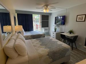 a hotel room with a bed and a desk and a television at The Frederiksted Hotel in Frederiksted