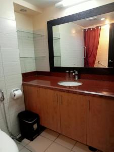 a bathroom with a sink and a mirror at Apo 201-Alta Vista De Boracay in Boracay