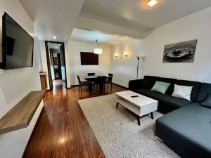 a living room with a couch and a table at Condesa Residence Amsterdam 303 Exquisite 1 Bedroom, 1 Bathroom Residence on Amsterdam Avenue in Mexico City
