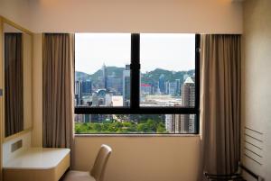 a room with a window with a view of a city at B P International in Hong Kong