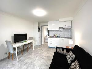 a living room with a couch and a table with a television at Broadwater Keys Holiday Apartments in Gold Coast