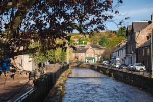 a river in a town with houses and buildings at 3-bedroom house for outdoor holidays in Alyth