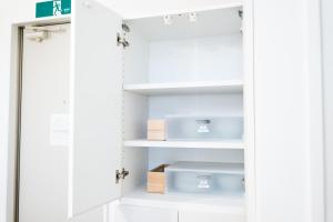a closet with white cabinets and blue boxes at RIVER CENTRAL HIROSHIMA in Hiroshima