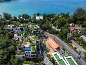 an aerial view of a neighborhood with houses and the ocean at Kata Gardens Penthouse sea view 4C in Kata Beach