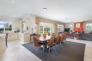 a kitchen and dining room with a table and chairs at Iona Park, Moss Vale in Moss Vale