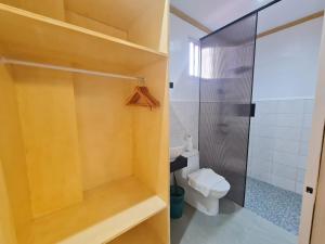 y baño con ducha y aseo. en Hotel Pressie by SMS Hospitality en Panglao