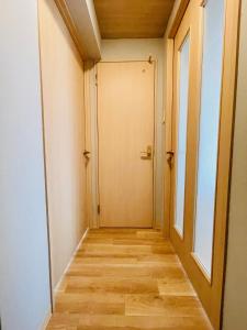 a corridor with a door in a room at 新規OPEN札幌駅徒歩圏内10-1【サービスアパートメントSAPPORO札幌ステーション】 in Sapporo