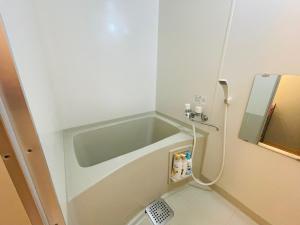 a small bathroom with a sink and a shower at 新規OPEN札幌駅徒歩圏内10-1【サービスアパートメントSAPPORO札幌ステーション】 in Sapporo